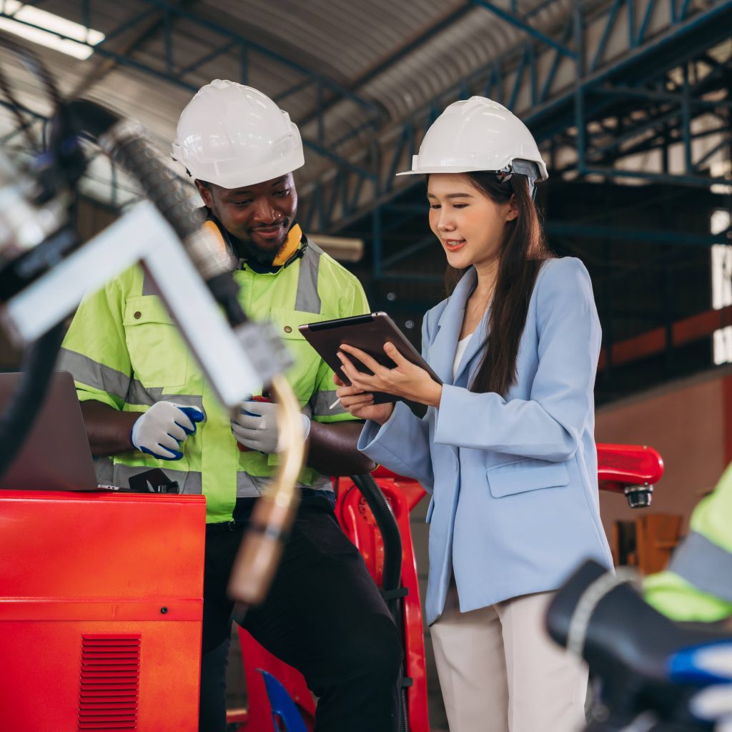 Safety manager showing digital safety training on a tablet to HVAC worker Safety manager showing digital safety training on a tablet to HVAC worker