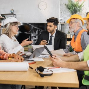five-multiracial-people-architects-sitting-at-desk-2023-11-27-05-08-54-utc-sq