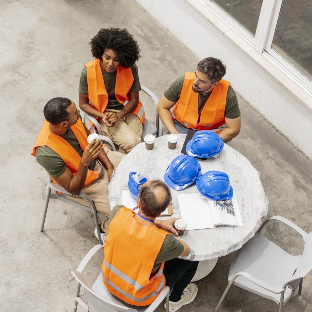 multiracial-engineers-team-having-a-coffee-break-d-2025-02-22-01-06-45-utc-sq Construction team discussing safety procedures during indoor meeting
