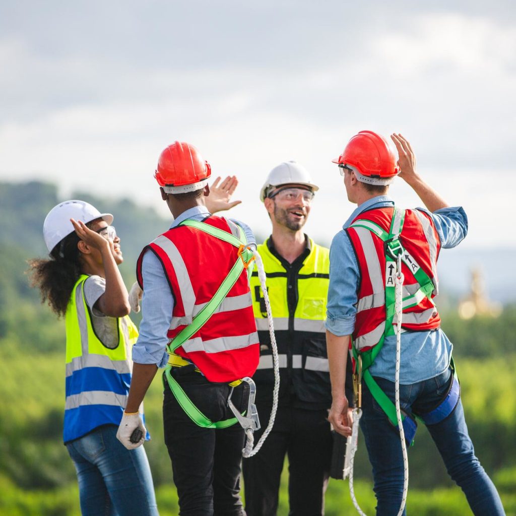 Construction crew holding outdoor safety meeting on job site Construction crew holding outdoor safety meeting on job site